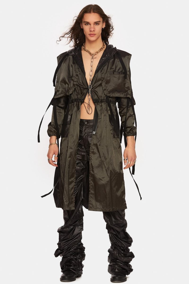 Unlined trench coat made from a black slicker with hood. Notch lapels with adjustable cords. Front zipper with double openings. Adjustable elastic cord at the waist. Water repellant.