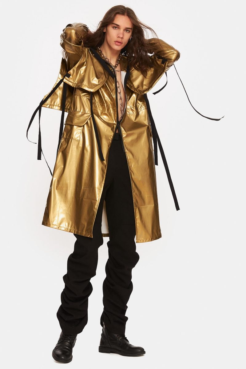 Unlined trench coat made from a gold slicker with hood. Notch lapels with adjustable cords. Front zipper with double openings. Adjustable elastic cord at the waist. Water repellant.