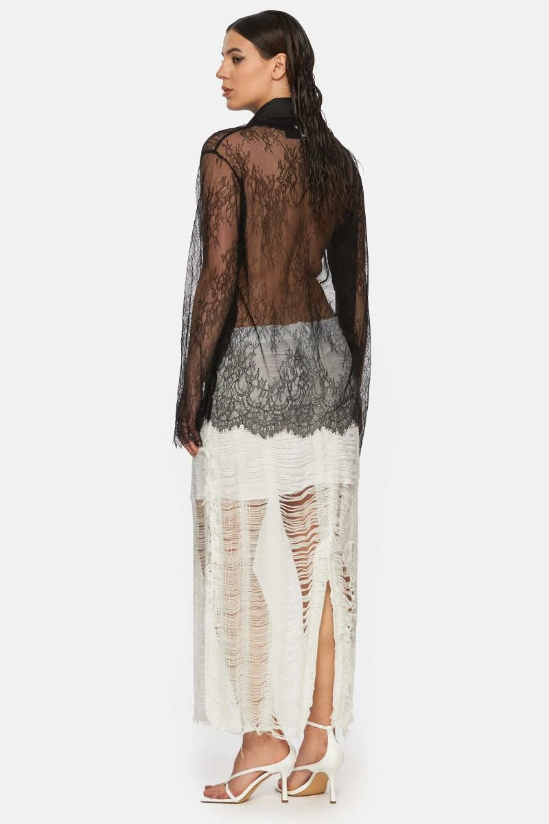 Sheer blouse with long sleeves made out of lace. Square V-neck.
