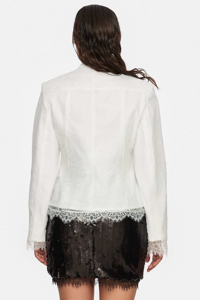 White denim jacket with an white lace overlay. Front zipper. No pockets. No  lining.