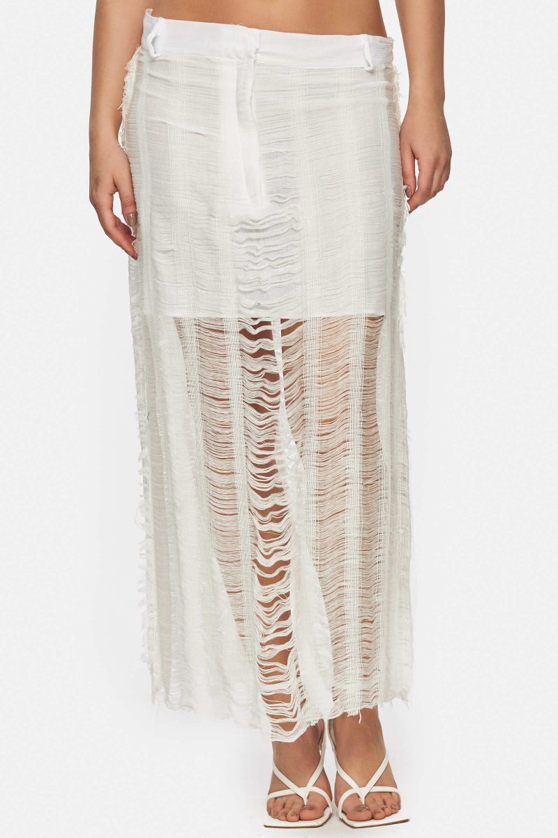 Midi skirt with a laddered knit to create a sheer effect. Shredded hem detailing. Low waist. Doubled with linen.