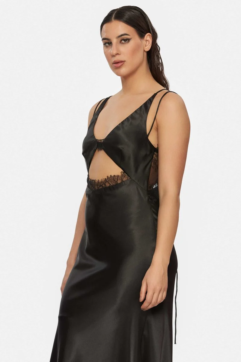 Slipdress made out of black satin with a front cut-out. Two spaghetti straps that are adjustable at the back. See through lace at the back that closes with 3 buttons.
